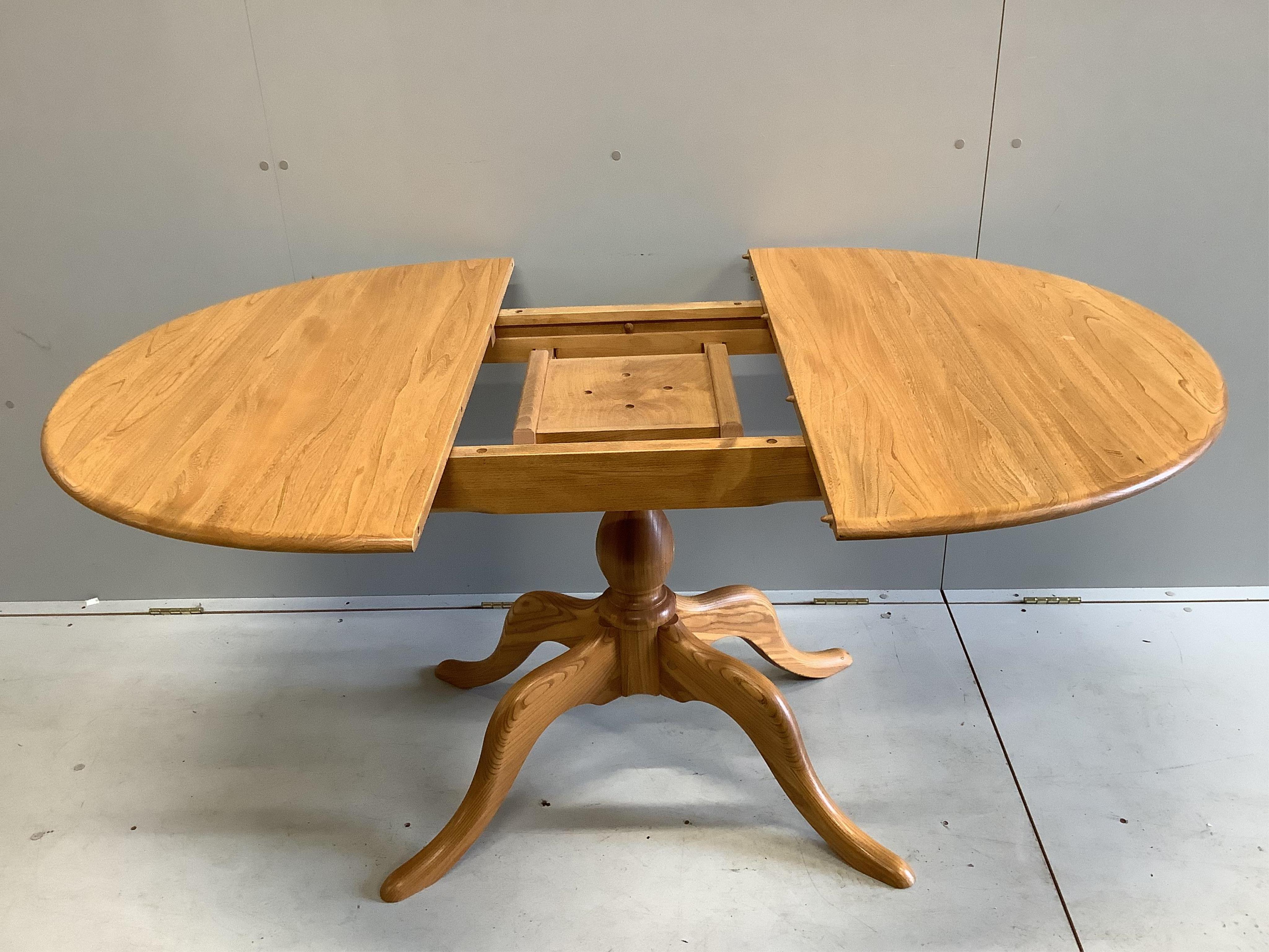 A modern Ercol elm dining table, width 110cm, depth 98cm, height 72cm (lacks spare leaf)